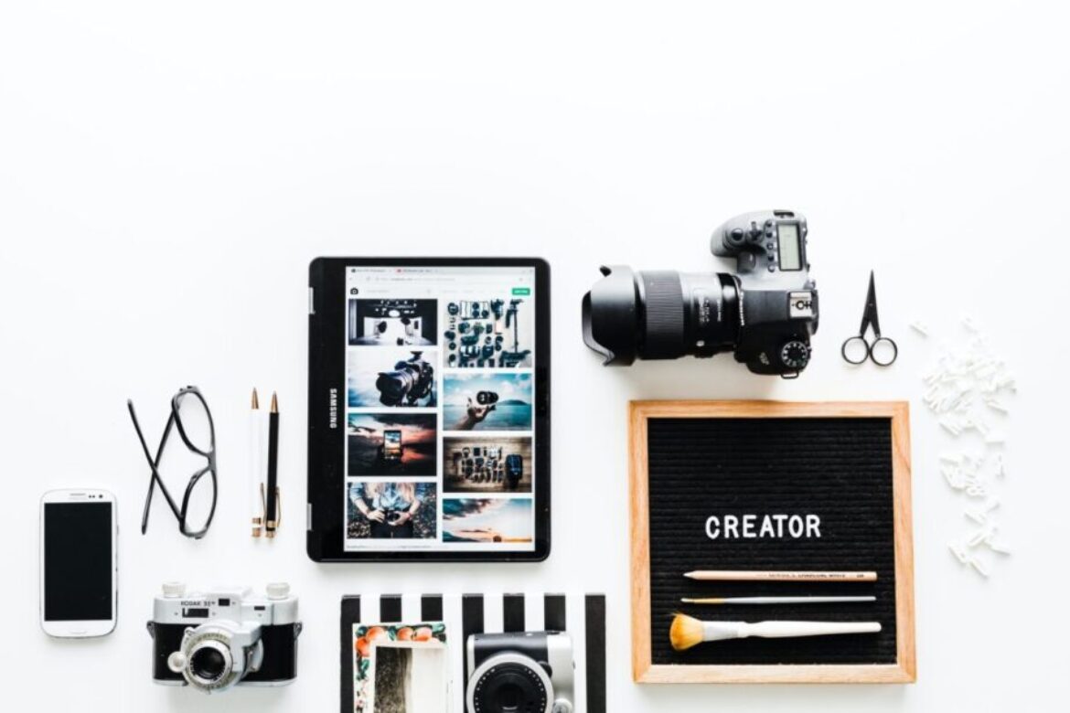 flat view of cameras beside computer tablet and smartphone