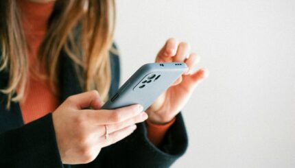 a woman holding a cell phone in her hands